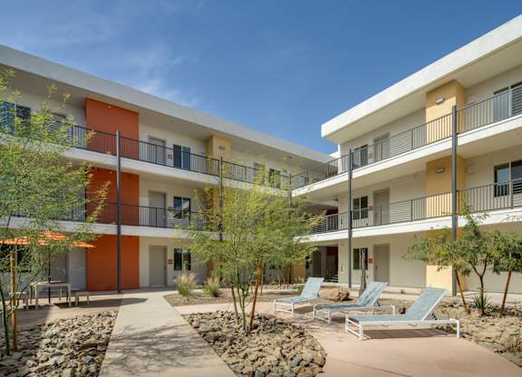 A modern building with orange and white balconies.