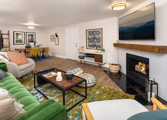 A living room with a fireplace and a television.