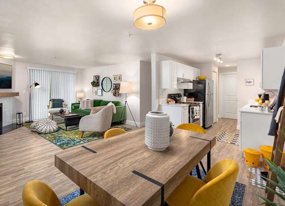 A modern dining room with a wooden table and yellow chairs.