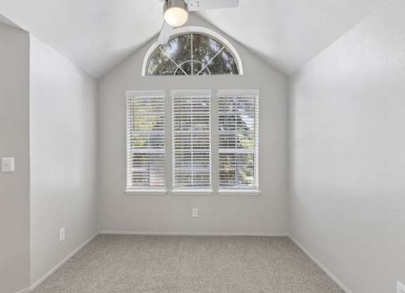 A room with a window covered in blinds.