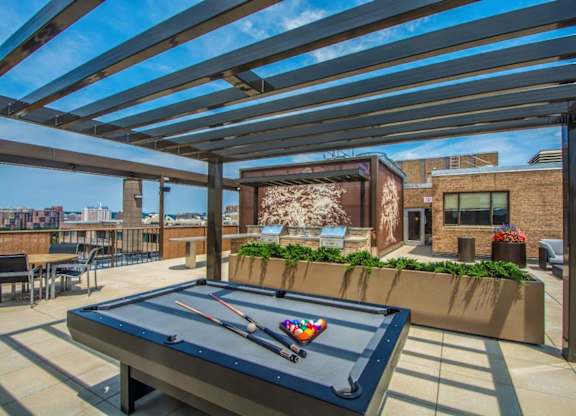 A pool table is set up on a patio.