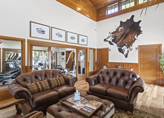 a large living room with leather couches and a coffee table