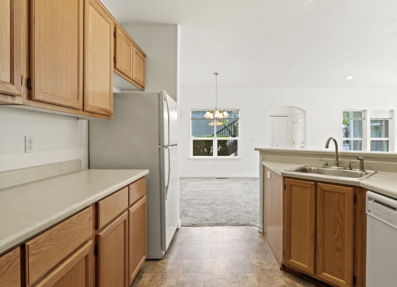 a kitchen with wooden cabinets and white appliances