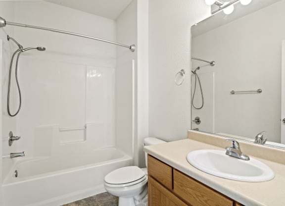 a bathroom with a toilet sink and shower