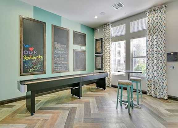 A room with a bench and a chalkboard with the words "We love our residents" written on it.