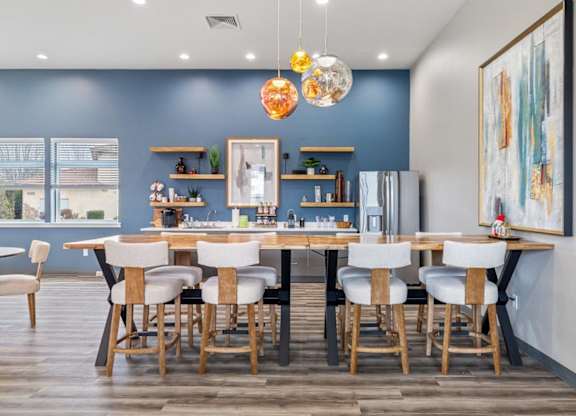 A dining room with a table set for six.