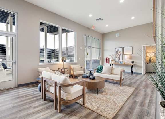 A living room with a white couch and a wooden coffee table.