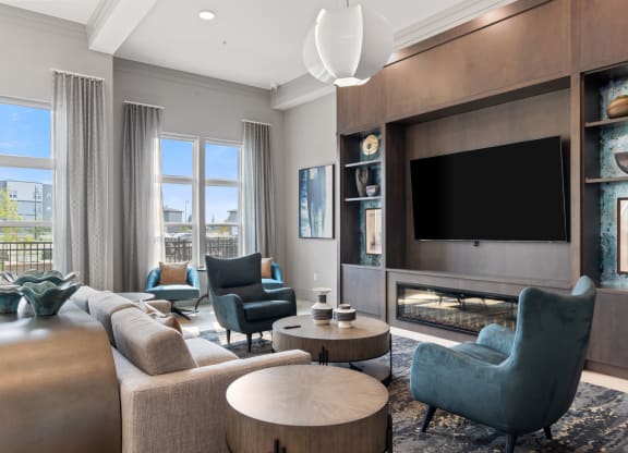 a living room with couches and chairs and a television