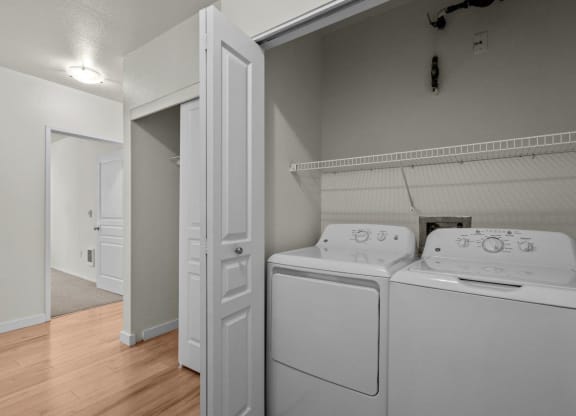 In-unit laundry with washer and dryer machine at Collins Circle apartments in the Goose Hollow district in Portland, Oregon.