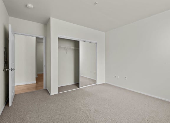 Bedroom with white walls and large double closet at Collins Circle apartments in the Goose Hollow district in Portland, Oregon.