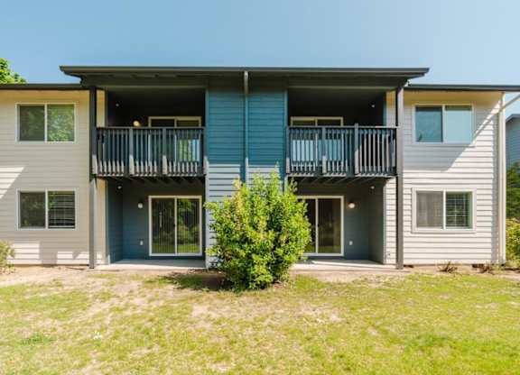 A two-story house with a balcony on the second floor.