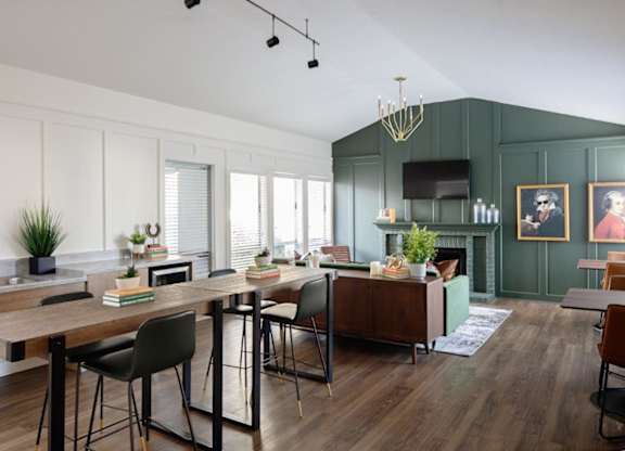 A modern kitchen with a wooden table and chairs.