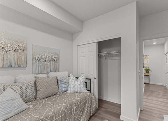 A bedroom with a bed and a painting on the wall.