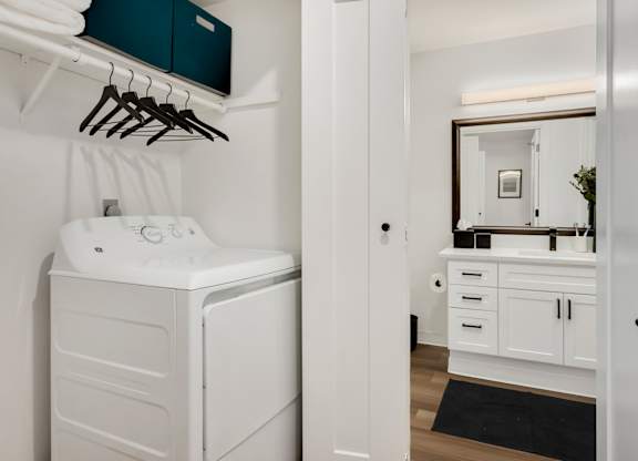 A white washing machine and dryer in a laundry room.