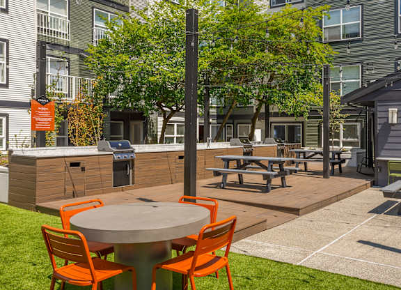 A patio with a table and chairs.