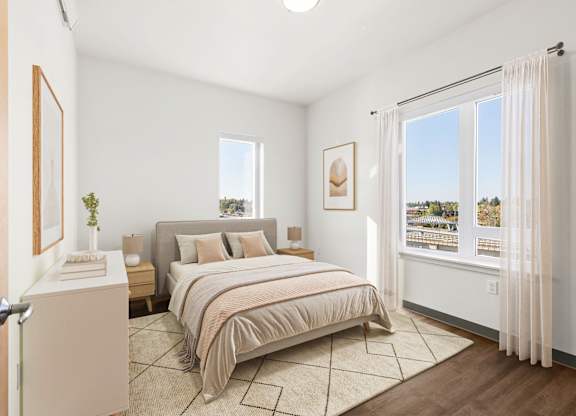 A bedroom with a large bed and a view of the outdoors through the window.