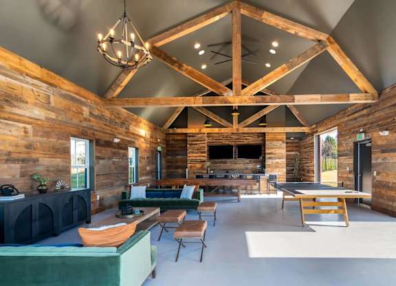 A wooden log cabin interior with a large open floor plan.