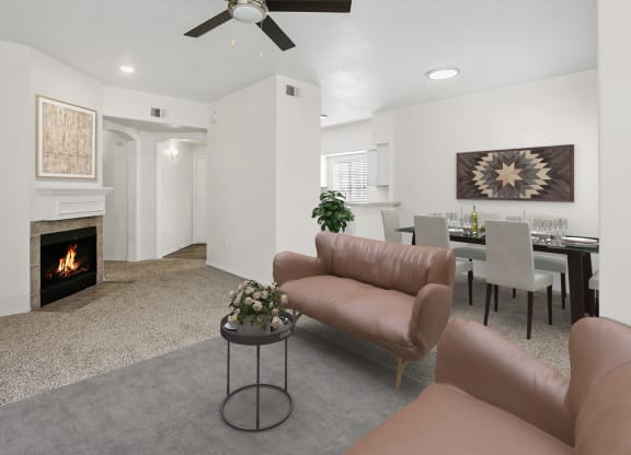 a living room with couches and a table and a fireplace