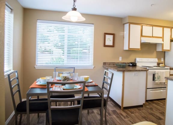 a kitchen and dining room with a table and chairs