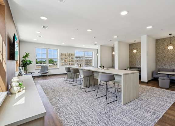 A modern kitchen with a dining area and a view of the ocean.