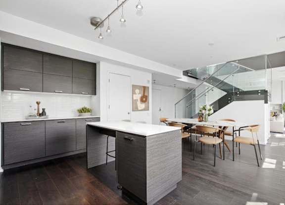 a kitchen with a large island and a dining table