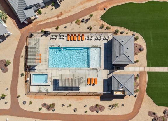 an aerial view of a house with a pool and a lawn