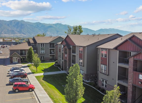 an aerial view of an apartment complex with mountains in the background