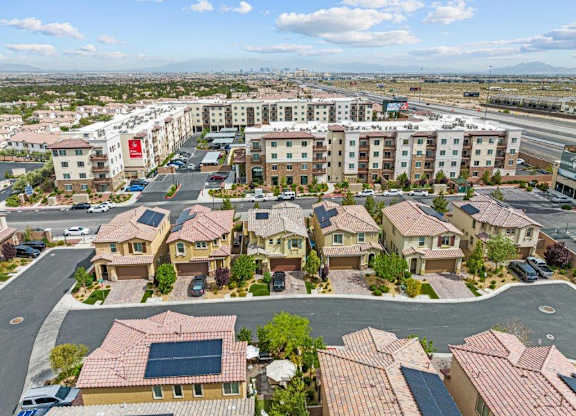 an aerial view of a neighborhood with houses and a parking lot