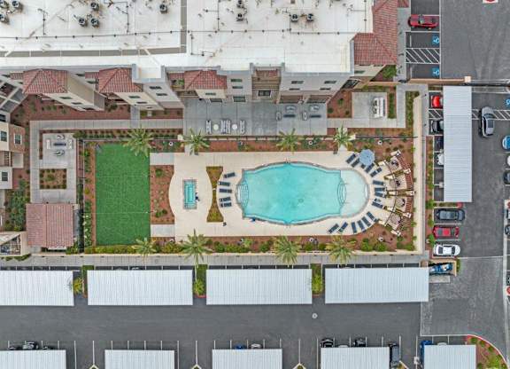 an aerial view of a pool in the middle of a parking lot