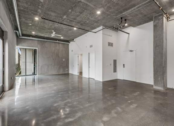 A large, empty room with concrete floors and walls.