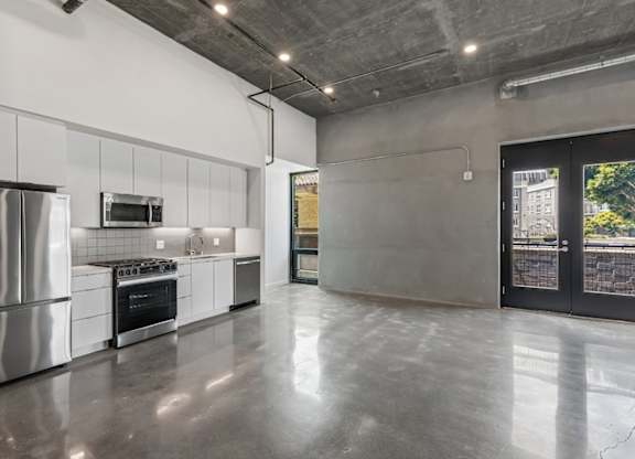 A modern kitchen with stainless steel appliances and a large island.