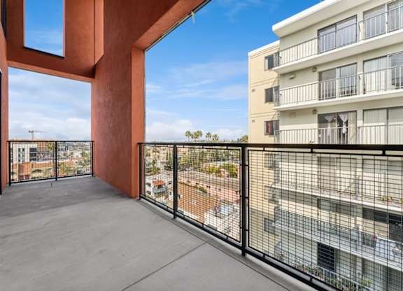 A balcony with a view of a cityscape.