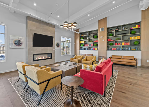 a living room with couches and chairs and a fireplace