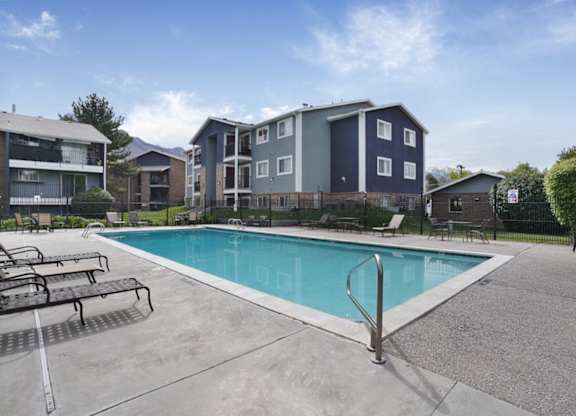 A swimming pool in front of apartment buildings.