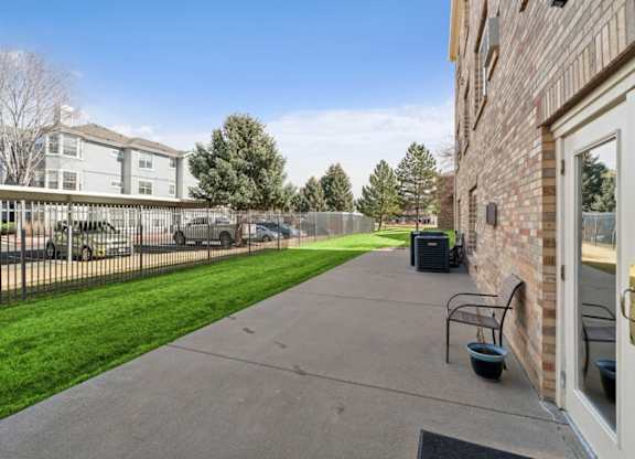 A residential area with a sidewalk and a building on the right.