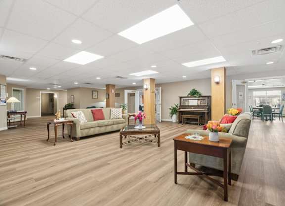 A spacious living room with wooden floors and furniture.