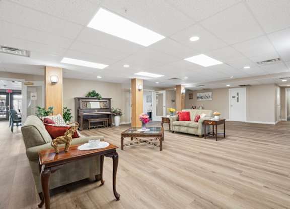 A spacious living room with wooden floors and furniture.