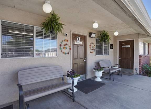A bench is on the porch of a house.