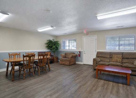 A living room with a dining table and chairs.