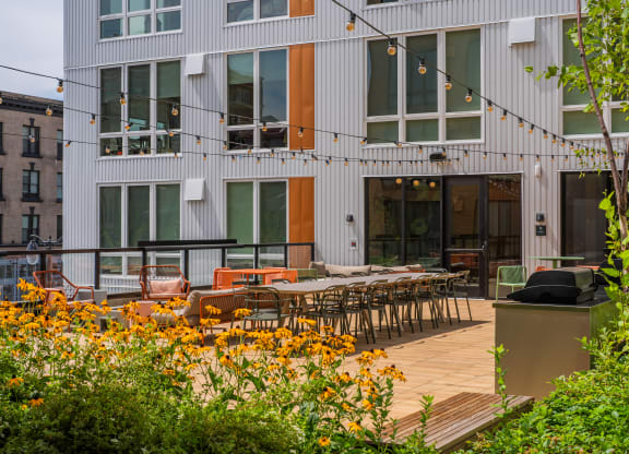 The Warren Apartments patio with dining and hanging lights
