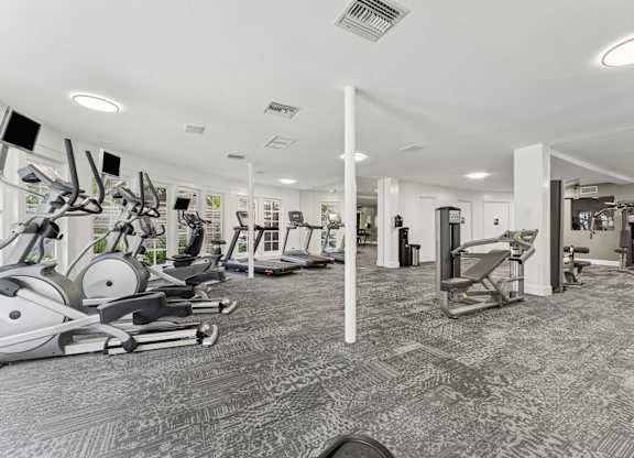 A gym with a variety of exercise equipment.