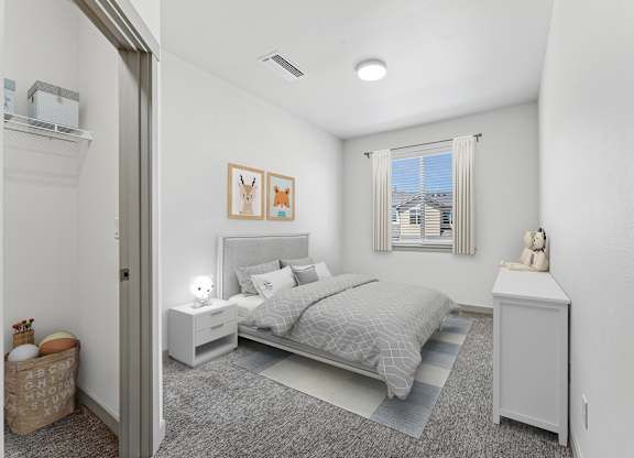 A bedroom with a bed, nightstand, and a window with a view of a building outside.