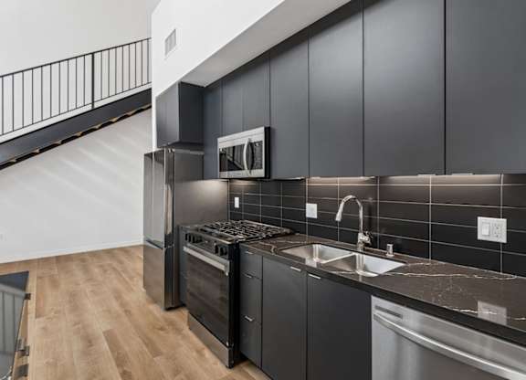 A modern kitchen with a stainless steel dishwasher and oven.