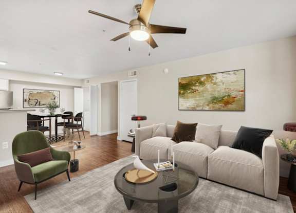 A living room with a green chair and a white couch.