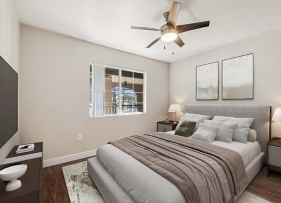 A bedroom with a bed, nightstands, and a ceiling fan.