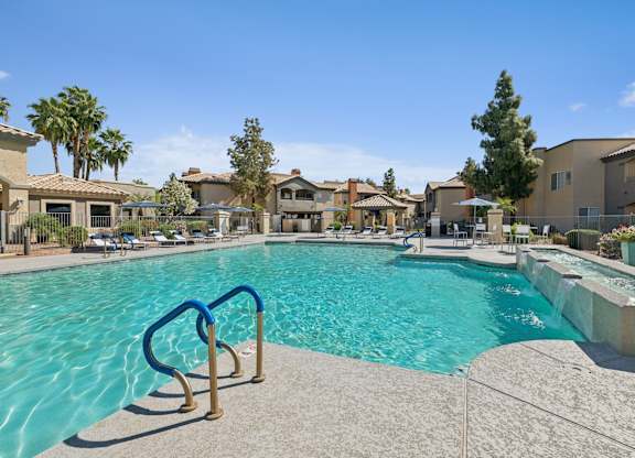 A swimming pool with a blue ladder in the foreground.