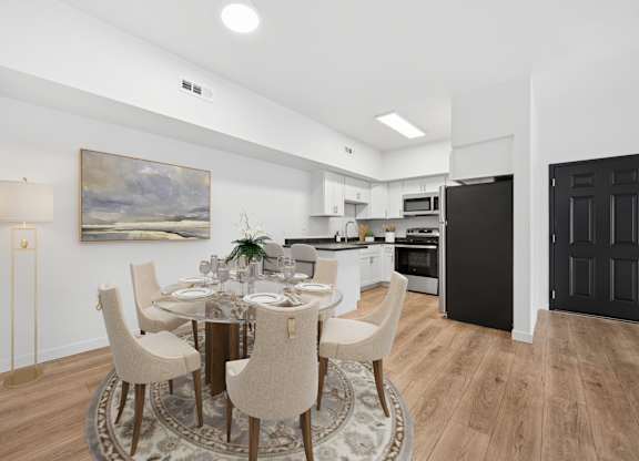 A modern dining room with a round table set for six.