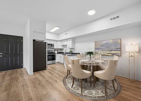 A modern kitchen with a dining table set for four.