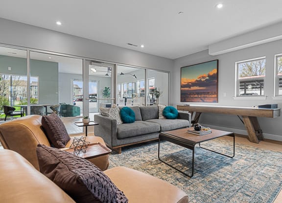 a living room with a couch coffee table and a ping pong table