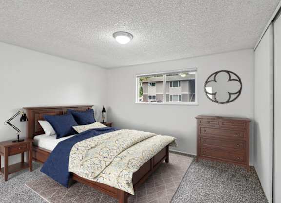 A bedroom with a bed, nightstand, and a window with a view of a building outside.